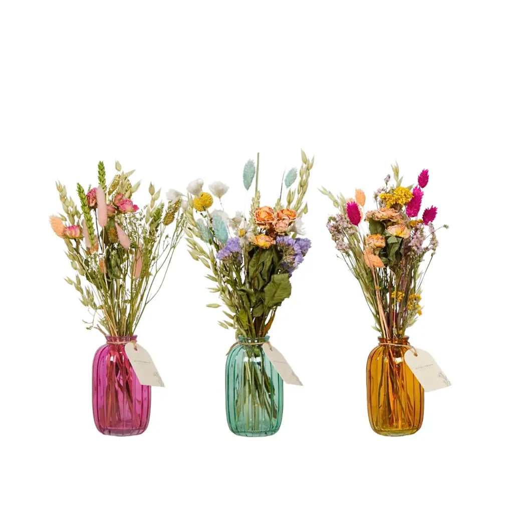 Pastel dried flowers pre-arranged in a clear glass bottle display